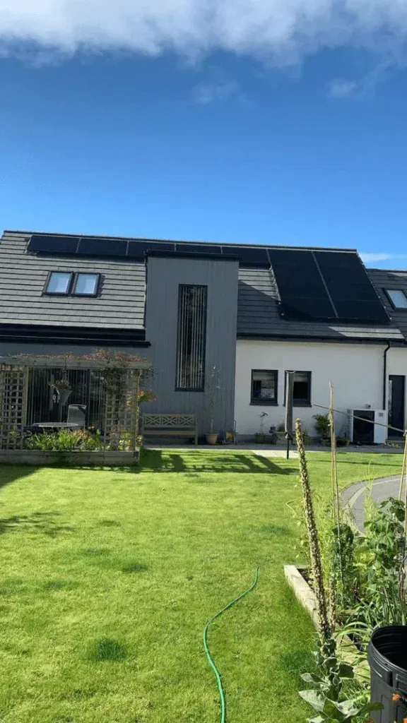 Modern house with solar panels and garden