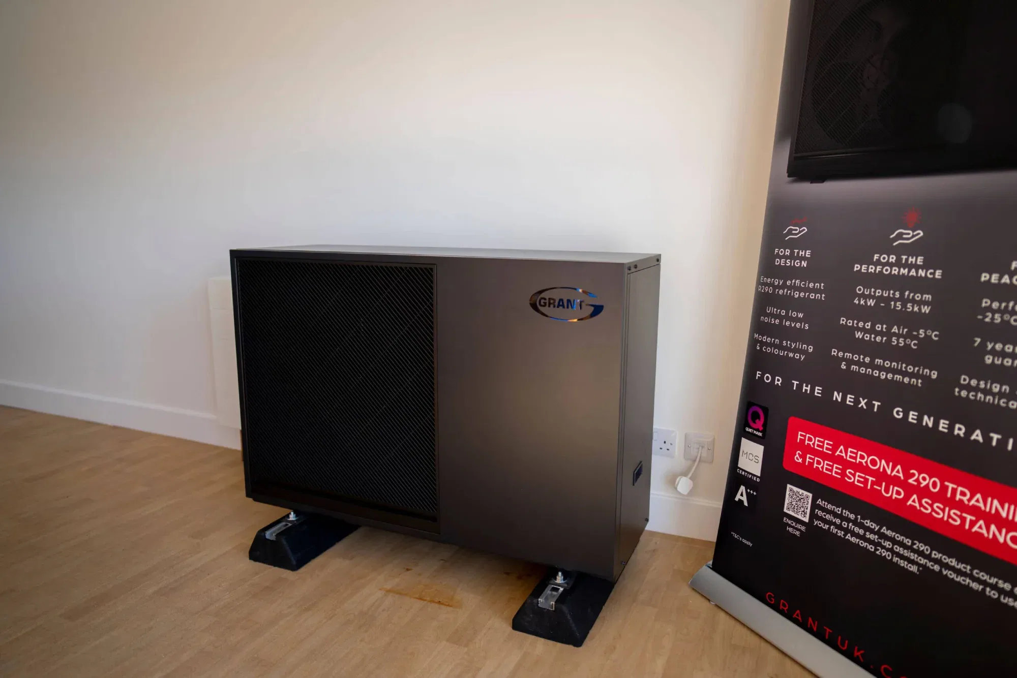 Indoor heat pump unit beside informational banner