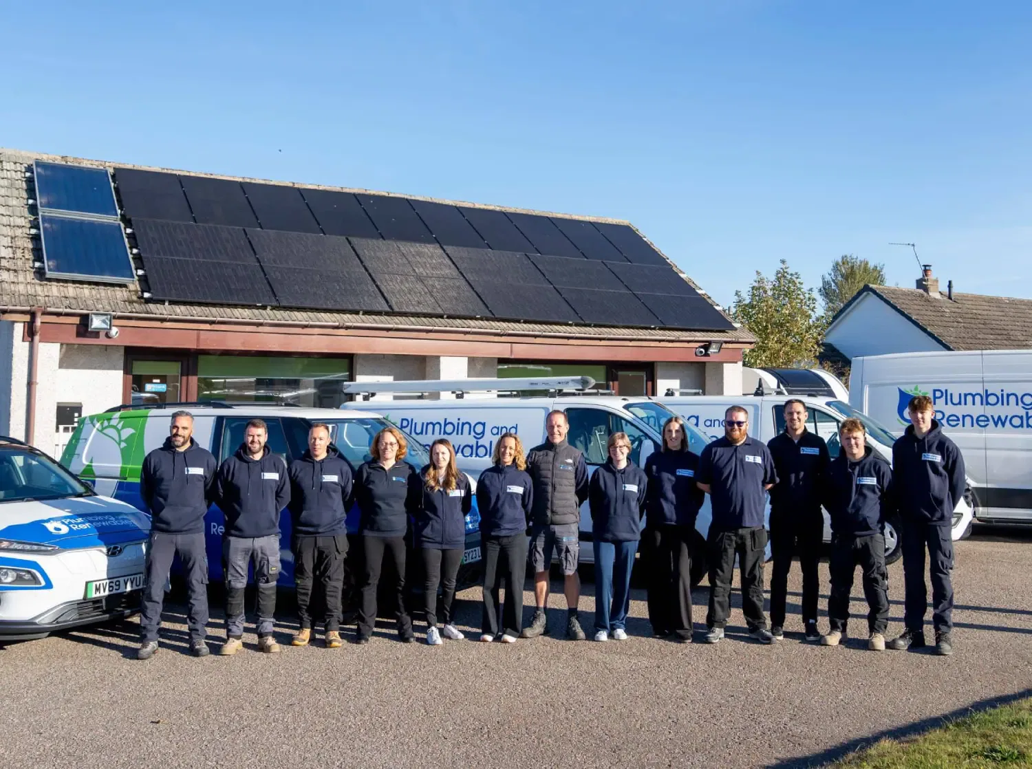 Team of workers with solar panels and vans
