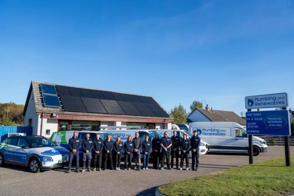 Plumbing and Renewables team outside solar panel building