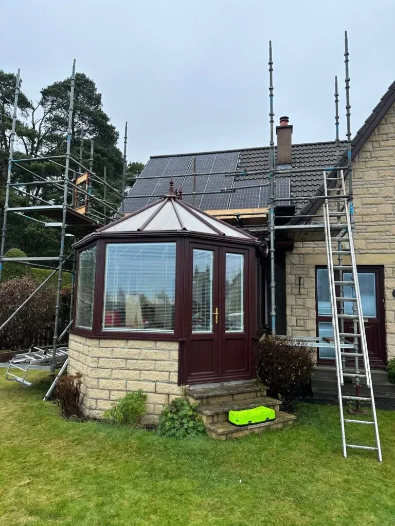 House with solar panels and scaffolding