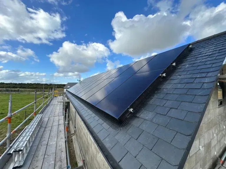 Solar panels on slate roof under blue sky