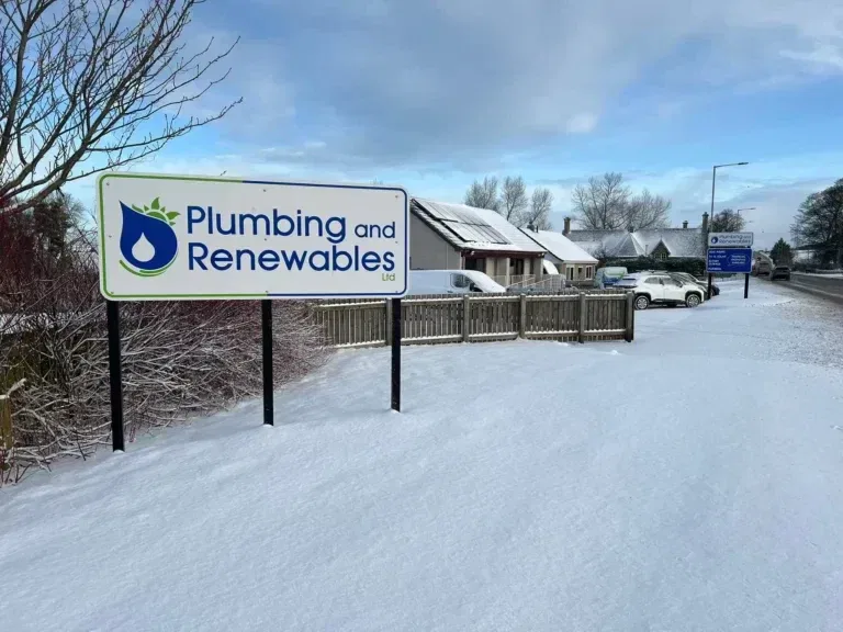 Snowy scene with Plumbing and Renewables sign