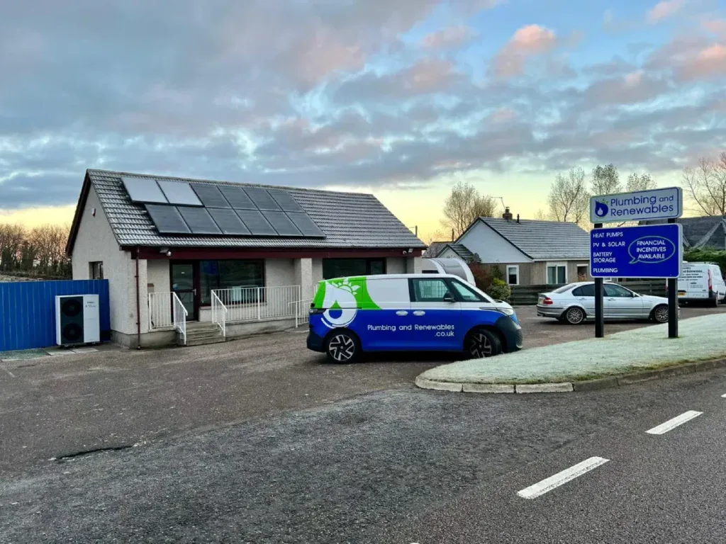 Building with solar panels and company van.